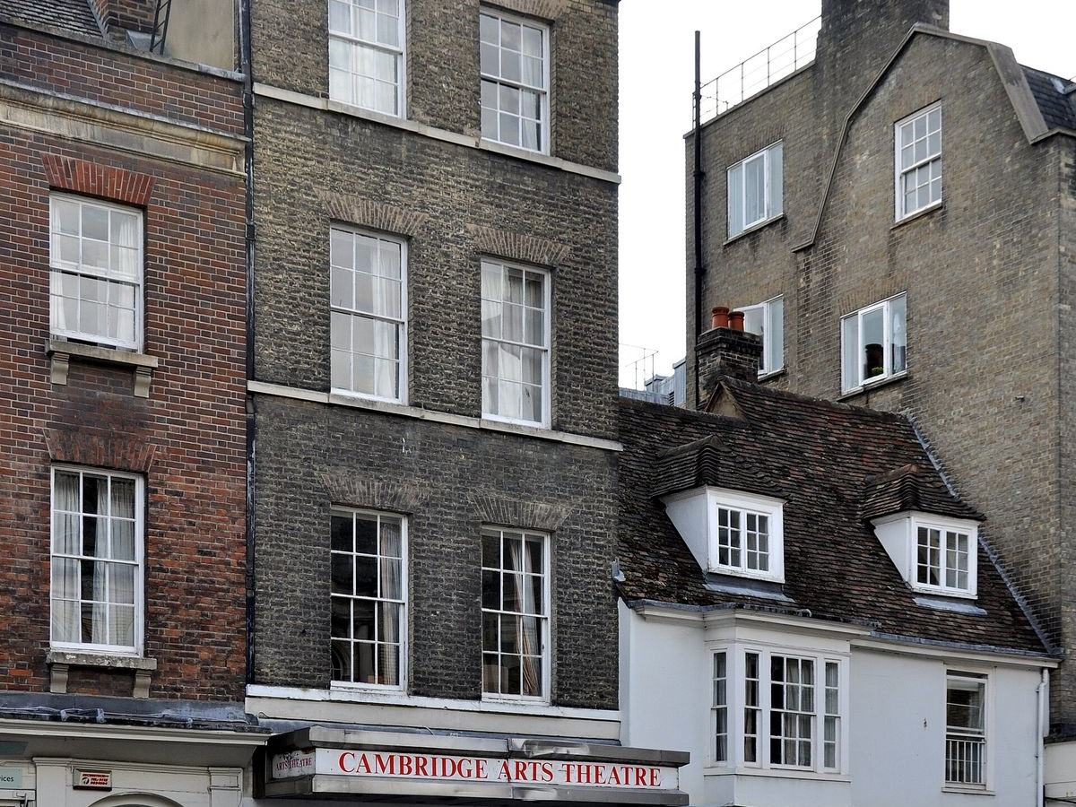 The Cambridge Arts Theatre sign below Georgian brick houses in the city centre