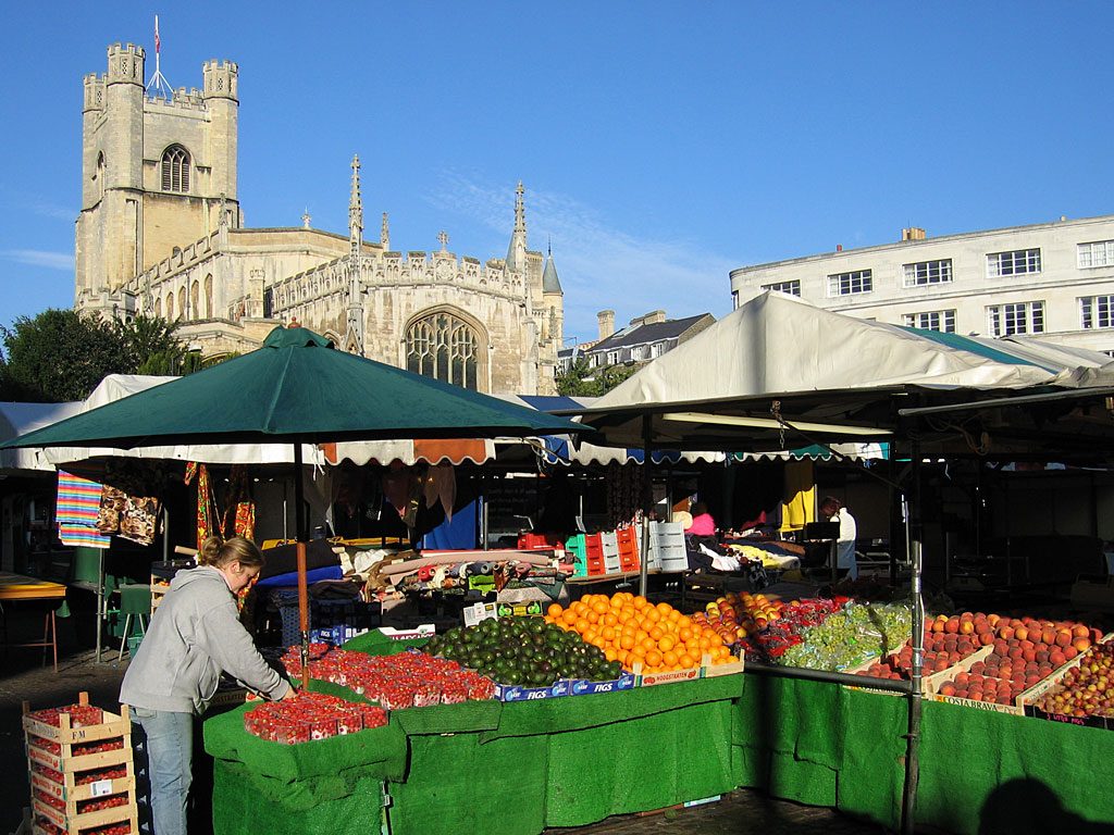 A fruit stall on Market Square with Great St Mary's behind