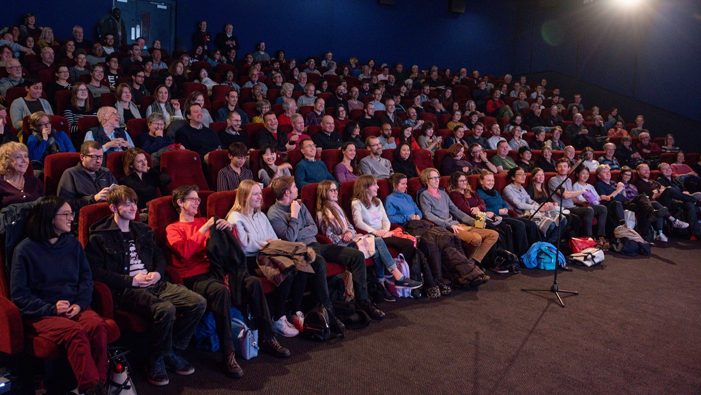 A full cinema auditorium waiting for a screening at the Cambridge Film Festival