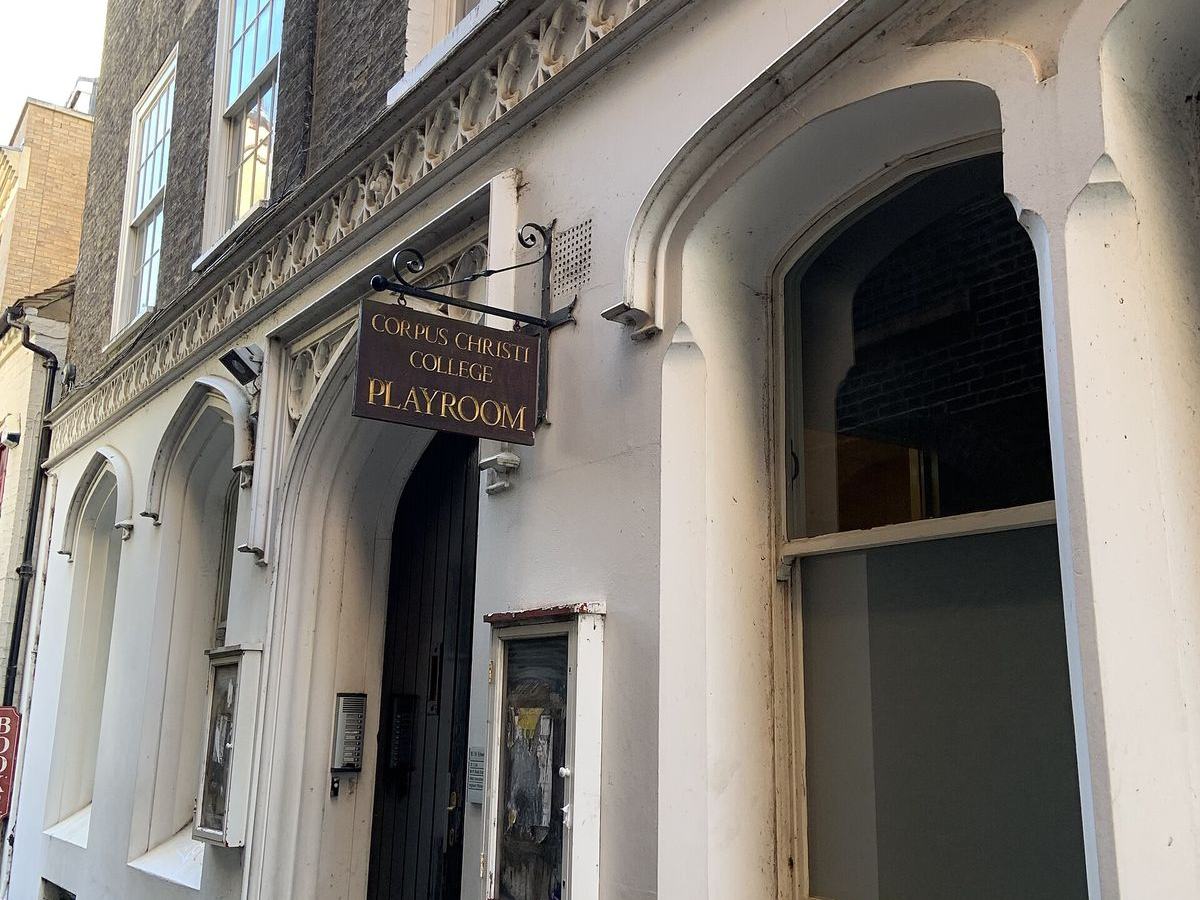 The Corpus Christi College Playroom sign above an arched doorway on St Edward's Passage