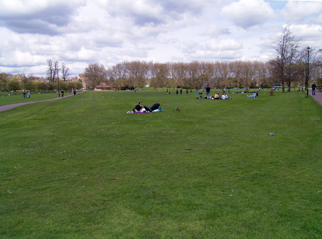 Jesus Green in Cambridge with open grass and trees, looking toward the pavilion by the river footbridge