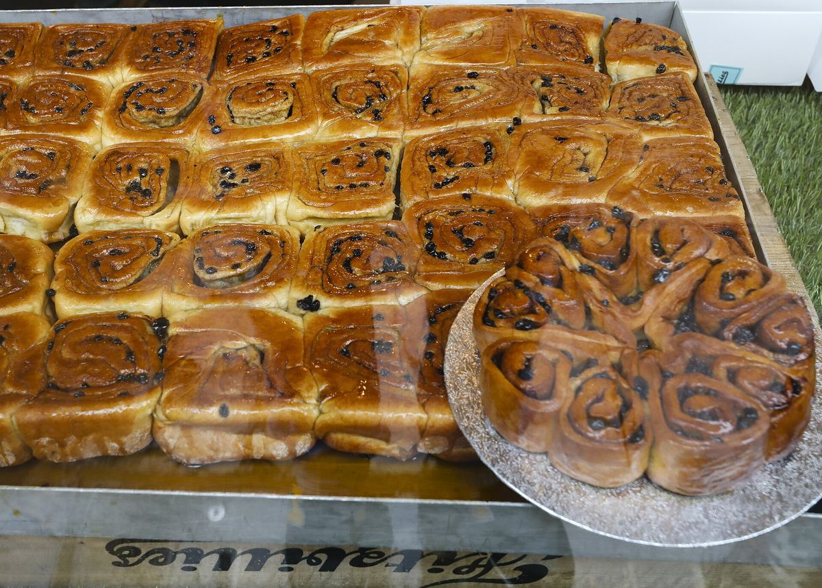 A tray of glazed Chelsea buns in a Fitzbillies display