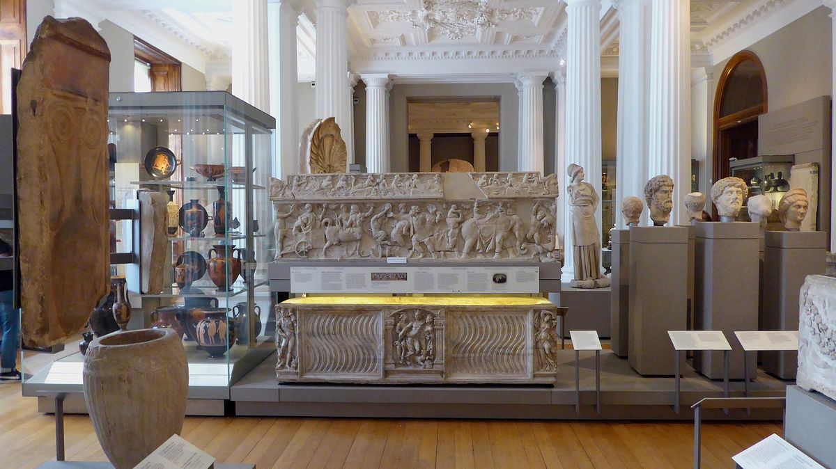 A gallery of Greek and Roman antiquities with a carved sarcophagus in the centre