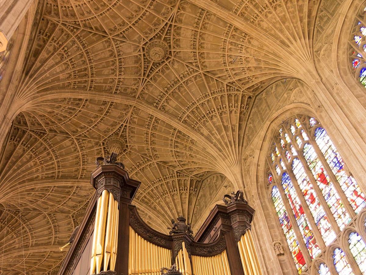 The stone fan vault of King's College Chapel above the organ and stained glass windows