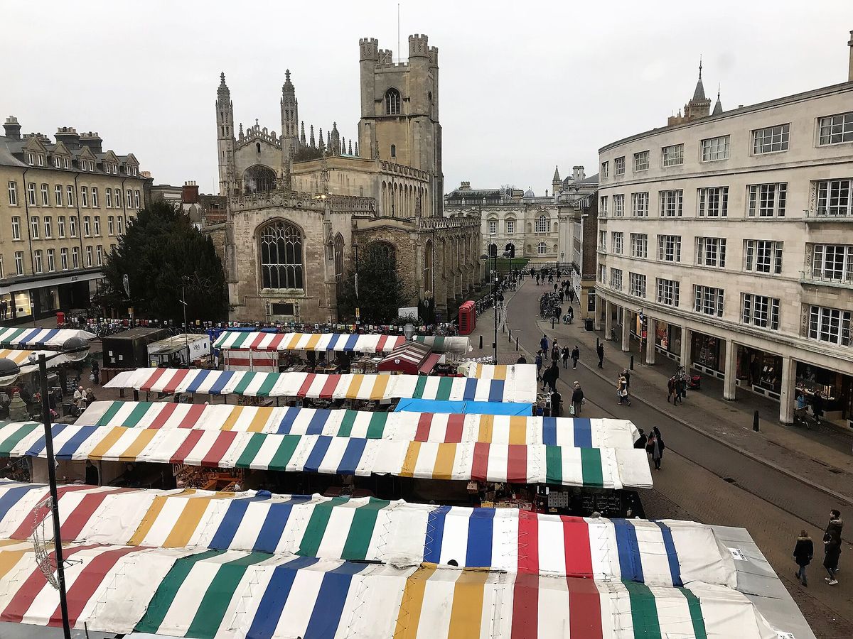 Market stalls in Cambridge Market Square with Great St Mary's church behind