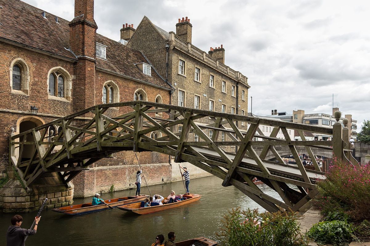 The wooden Mathematical Bridge crossing the River Cam at Queens' College, with punts below