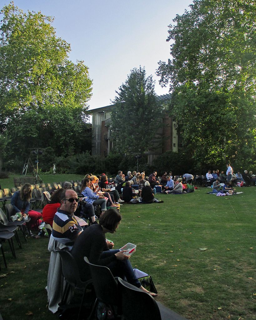 Theatregoers picnicking on a college lawn before a Cambridge Shakespeare Festival performance