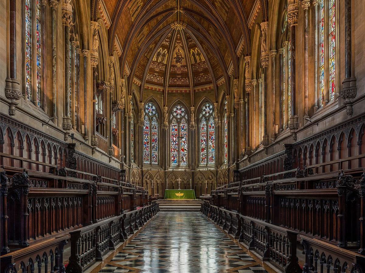 The long Victorian interior of St John's College Chapel with carved stalls and stained glass