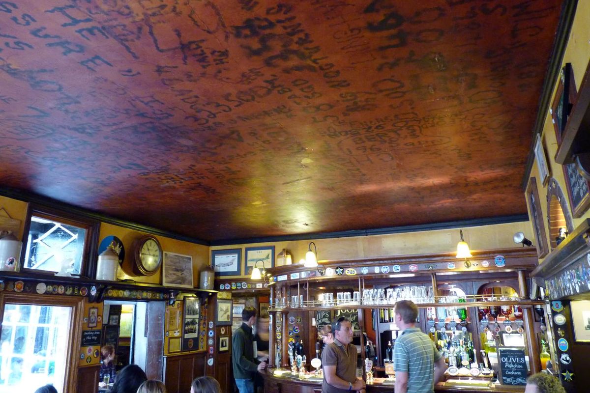 The ceiling of The Eagle pub covered with wartime graffiti above the bar