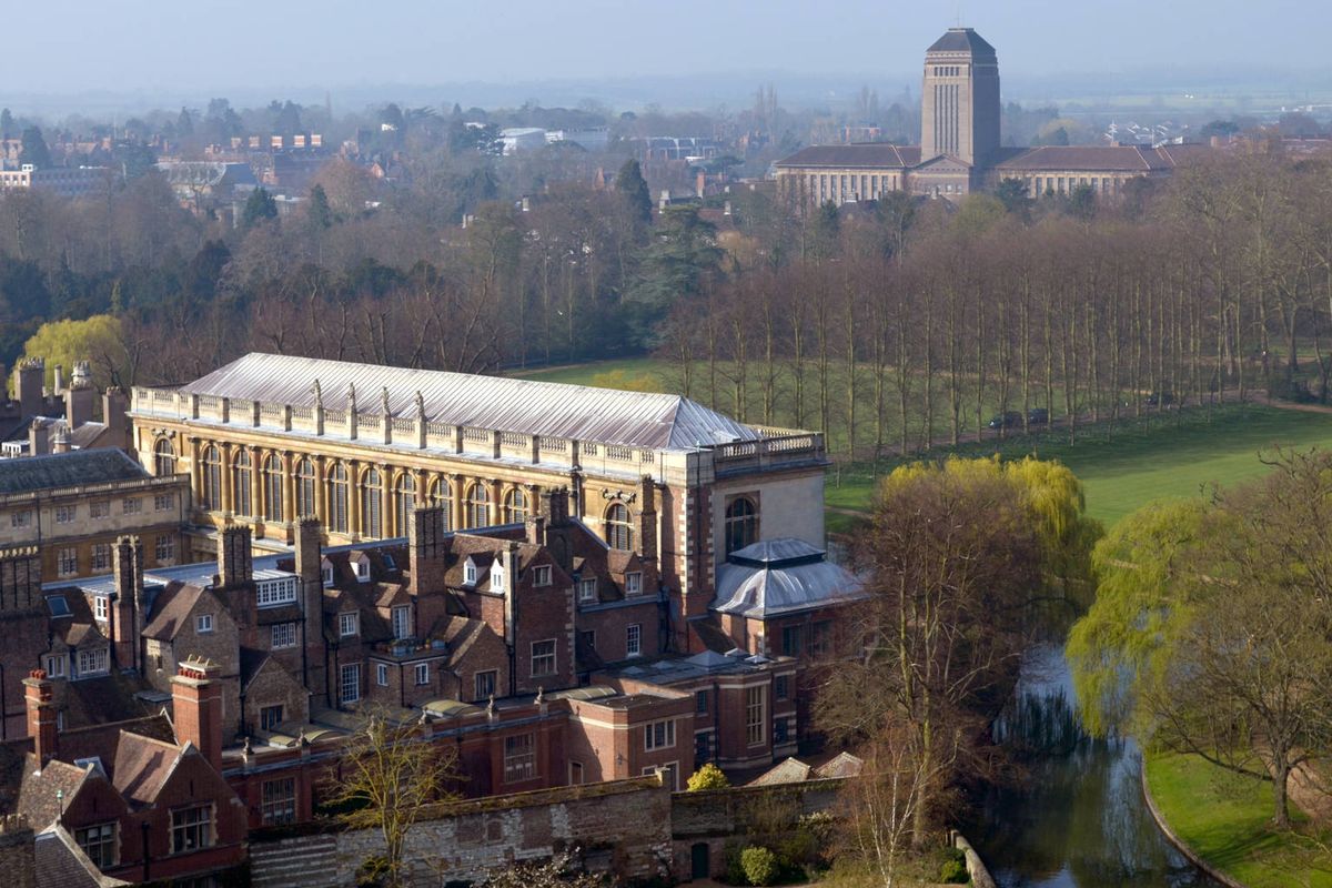 The Wren Library beside the river with the tower of Cambridge University Library on the skyline behind
